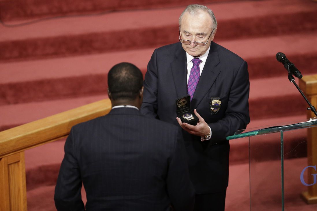 Bratton gives Holder's shield to his father<br/>